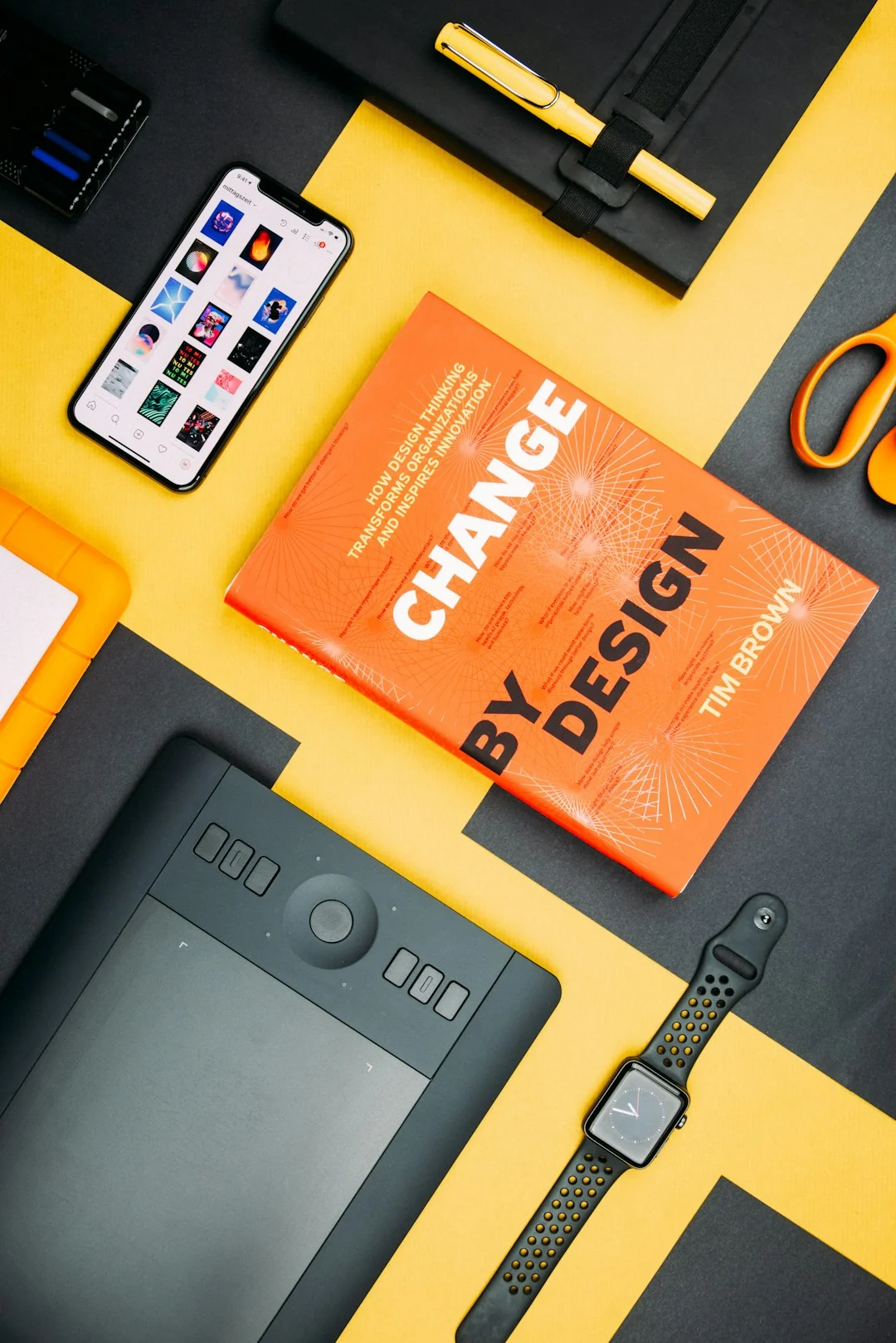 Business professional using a tablet and laptop with a hot drink, focusing on digital content review.